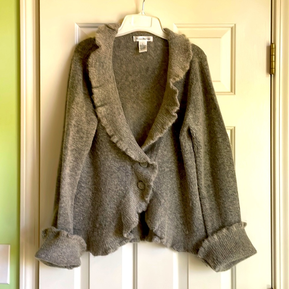 Cozy peplum style cardigan with ruffle trim